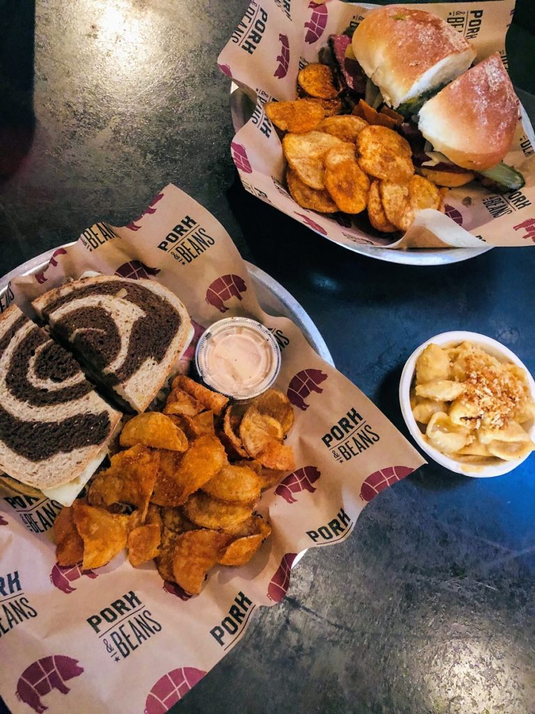 Picture showing two sandwiches and chips at Pork & Beans