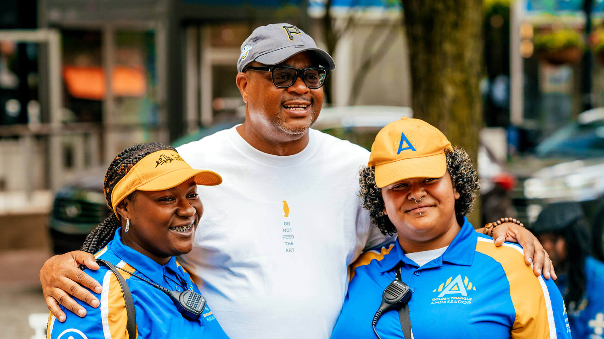 Three people come together for a happy photo in Market square