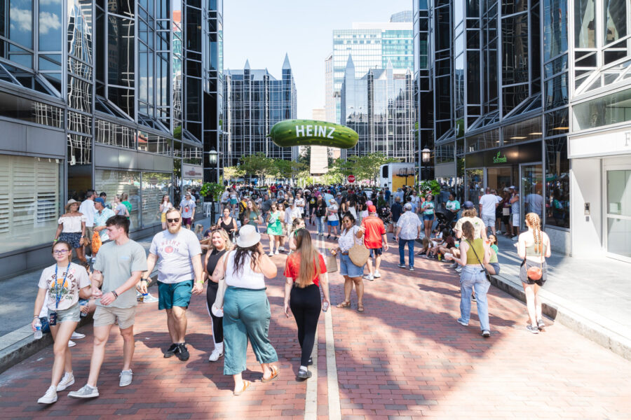 A crowd marches to the inflated Heinz Pickle in Market Square.