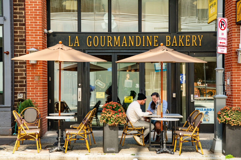 Folks eating outside on the sidewalk at La Gourmandine
